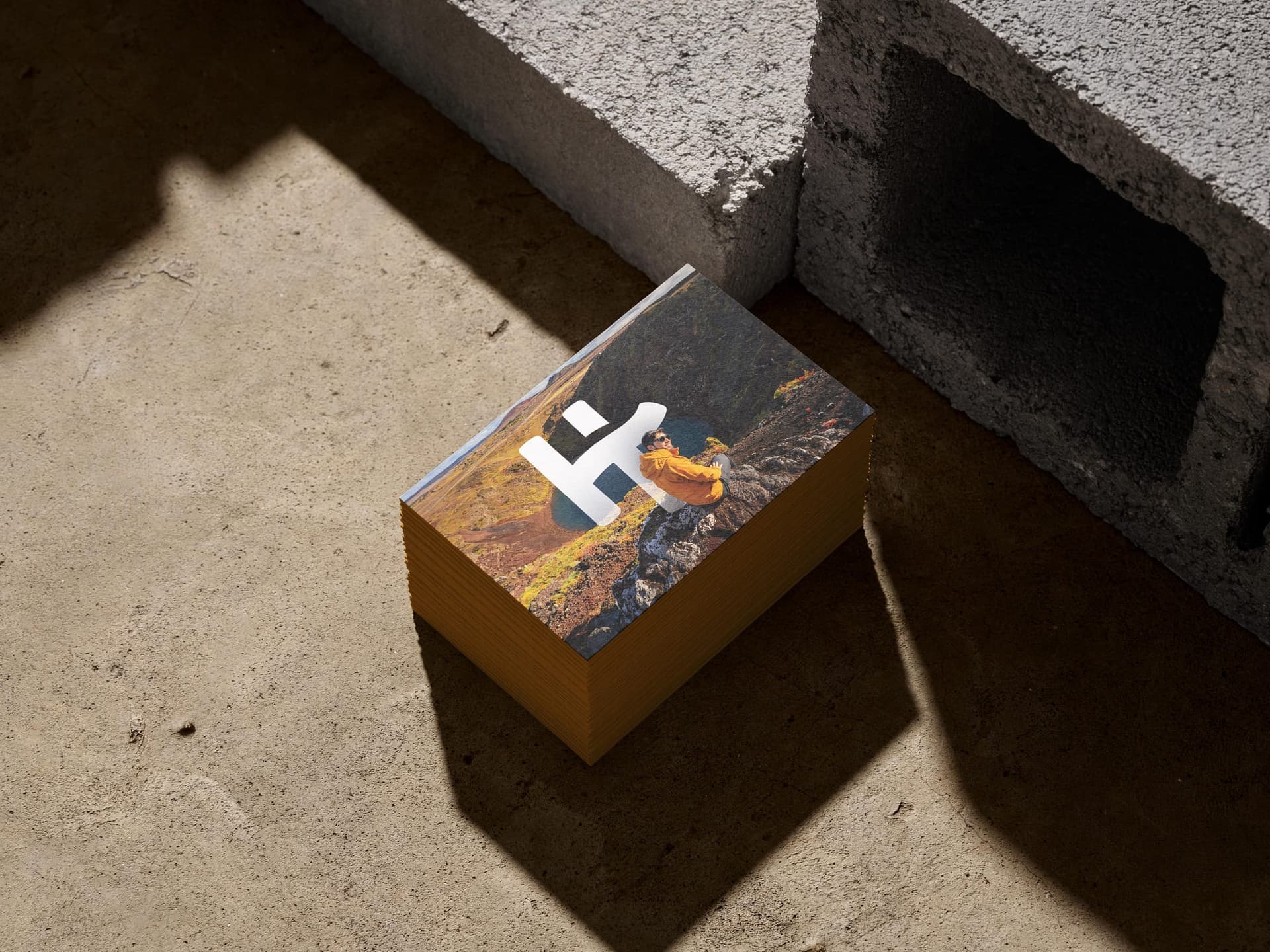 Stack of Holiday Tours business cards with a white symbol over Iceland photography