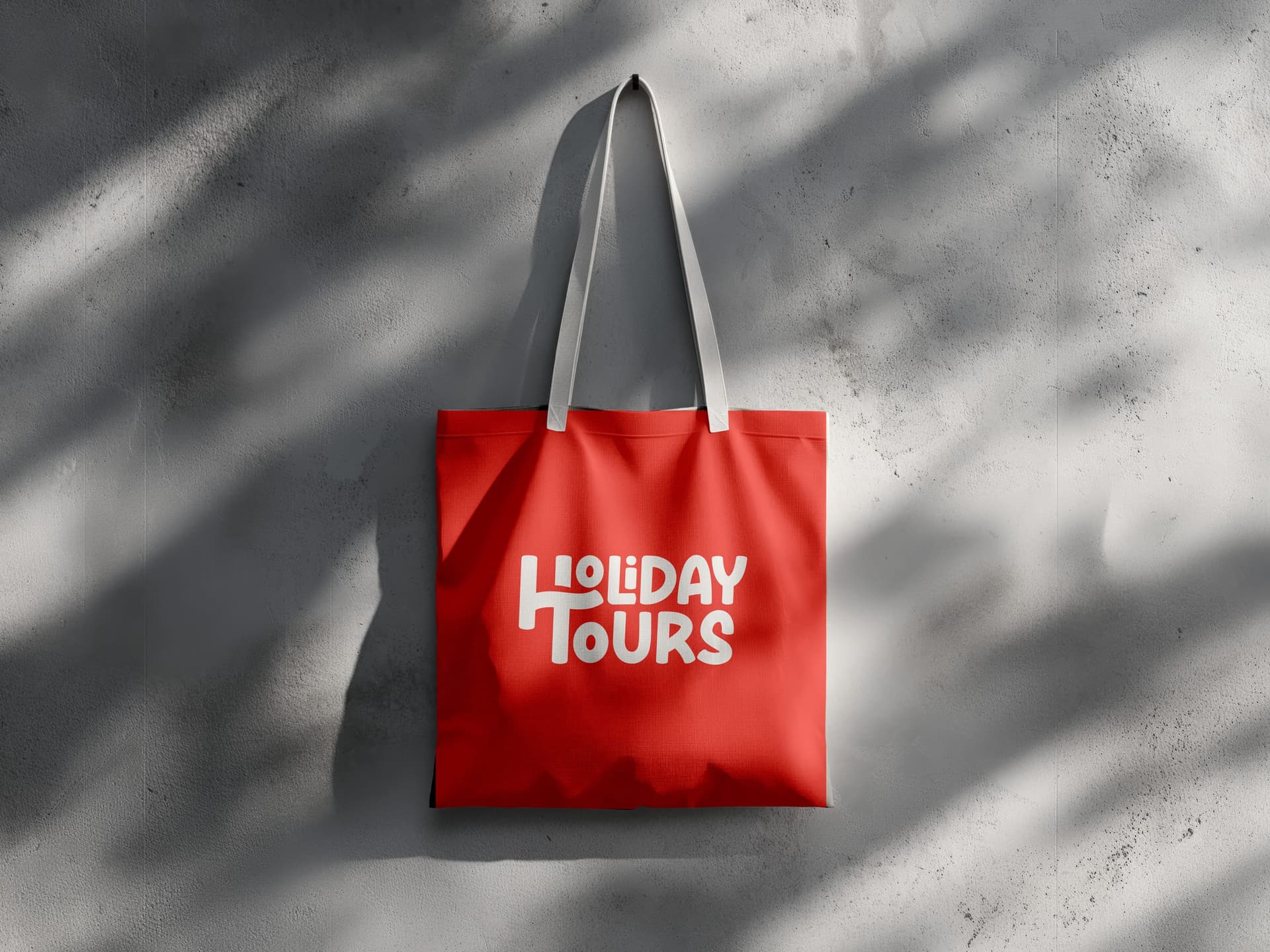 Red Holiday Tours tote bag with the white wordmark