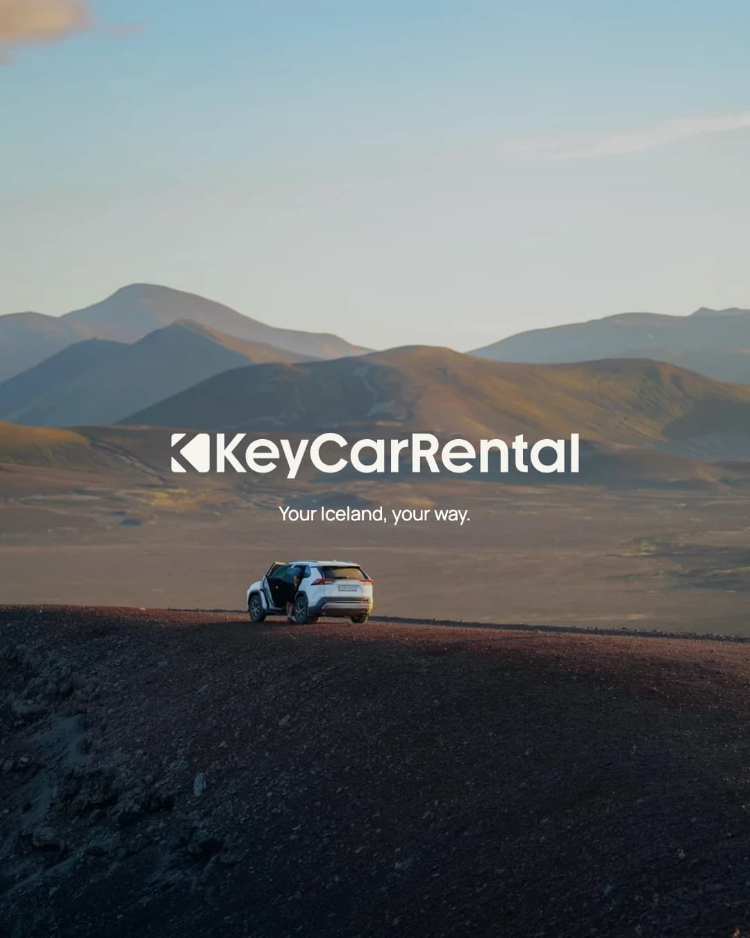 Key Car Rental — a car on an open road through Icelandic hills