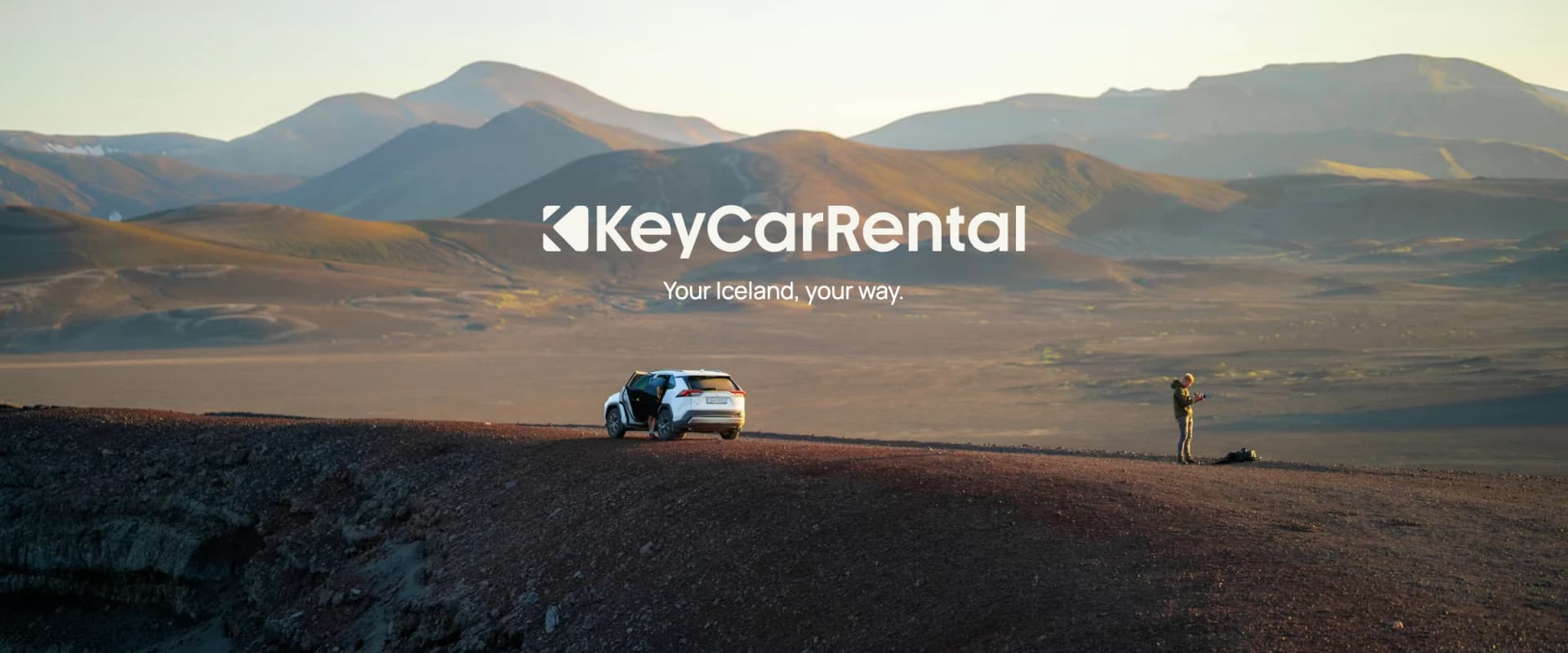 Key Car Rental logo above a traveller and car in the Icelandic hills — Your Iceland, your way.