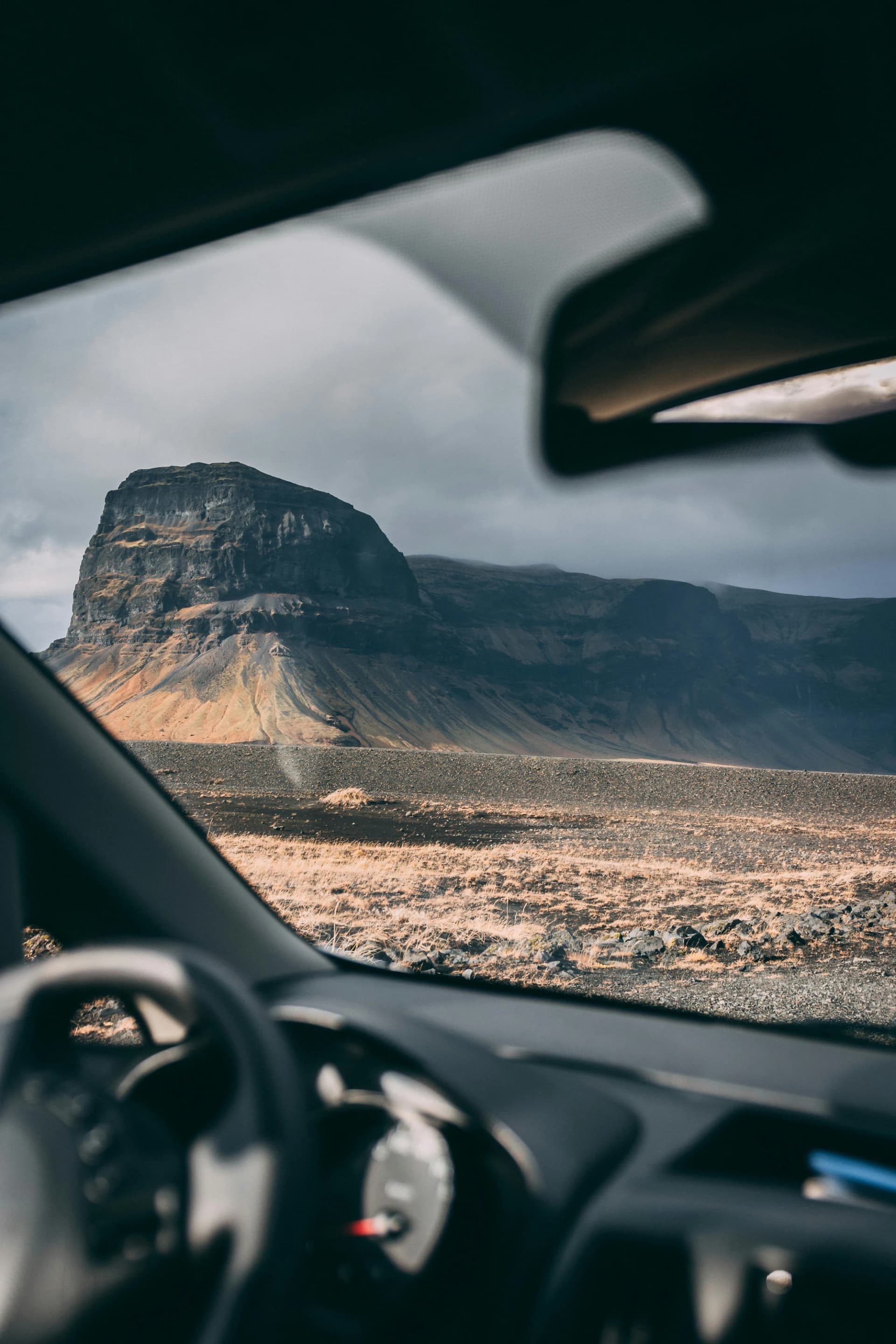 An Icelandic mountain seen through a vehicle window