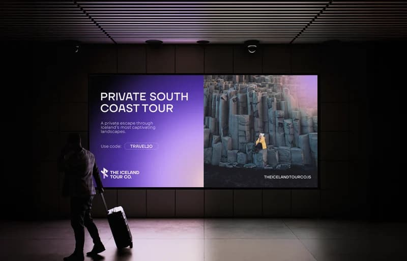 Outdoor campaign mockup from the ITC brandbook showing a lavender private South Coast tour panel beside basalt-cliff photography